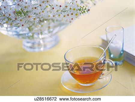 Stock Image - Flowers in Vase and Tea, High Angle View, Close Up, Differential Focus, In Focus, Out Focus. Fotosearch