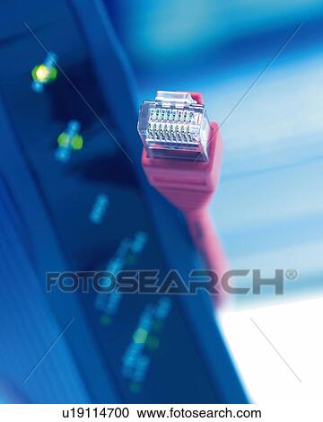 Stock Image - Cable and Modem, Close Up, Differential Focus, In Focus, Out Focus, Toned Image. Fotosearch