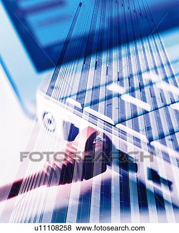 Stock Photo - Composite Photograph of Notebook Computer over Building, Close Up, Composition, Differential Focus, In Focus, Out Focus. Fotosearch