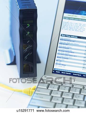 Stock Image - Computer and Modem on a Desk, Close Up, Differential Focus, In Focus, Out Focus. Fotosearch