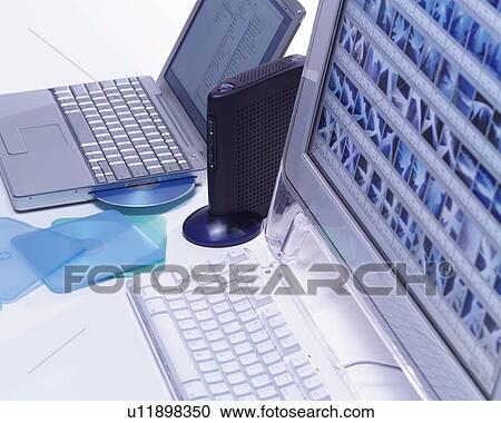 Stock Image - Computers on a Desk, High Angle View,. Fotosearch