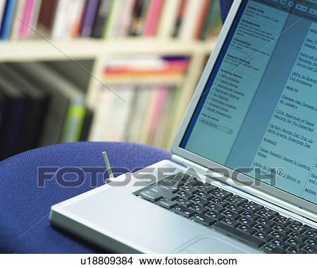 Picture - Notebook Computer on a Chair in Office, Close Up, Differential Focus, In Focus, Out Focus,. Fotosearch
