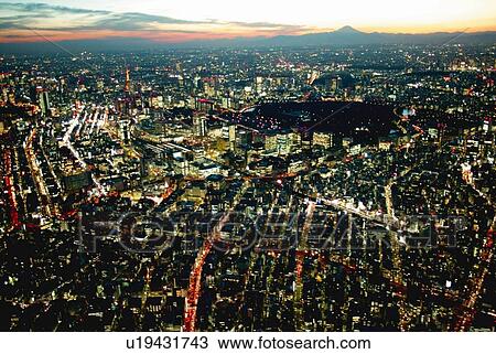 Stock Image - Mt. Fuji from the Sky above Kanda Area, Aerial View, Long Exposure. Fotosearch