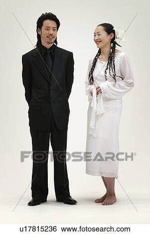 Stock Photograph - Man in Black and Woman in White, Front View. Fotosearch