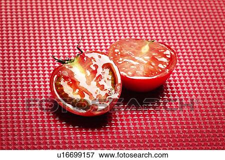 Stock Photo - Tomato Split into Two, High Angle View, Copy Space. Fotosearch