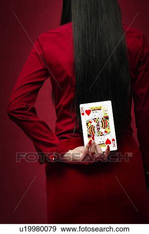 Stock Photo - Woman Showing a Card, Rear View. Fotosearch
