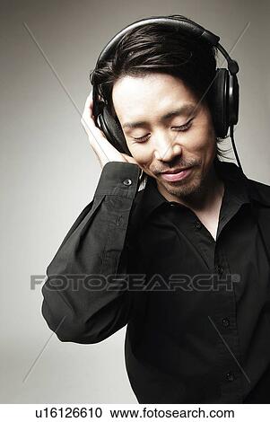 Young Man in Black Listening Music, Front View View Large Photo Image Stock Image - Young Man in Black Listening Music, Front View. Fotosearch