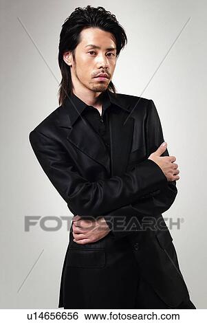 Stock Photograph - Young Man in Black Standing, Front View. Fotosearch