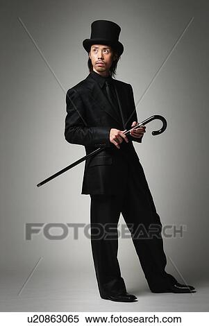 Young Man in Black with Hat and Stick, Side View View Large Photo Image Stock Photography - Young Man in Black with Hat and Stick, Side View. Fotosearch