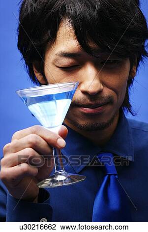 Stock Image - Young Man in Blue and Cocktail, Front View. Fotosearch