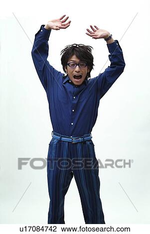 Stock Image - Young Man in Blue Jumping, Front View. Fotosearch
