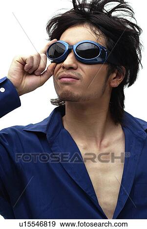 Stock Photo - Young Man in Blue Wearing Sunglasses, Front View. Fotosearch