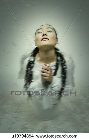 Picture - Young Woman with Wings Praying, High Angle View, Defocused. Fotosearch
