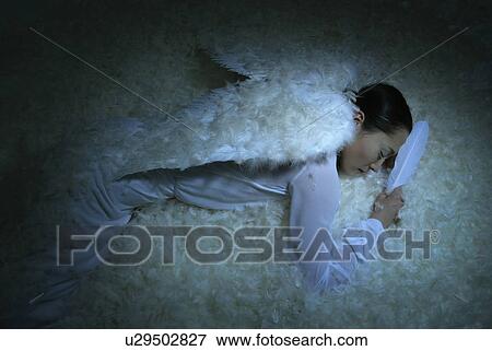 Young Woman with Wings Sleeping, High Angle View View Large Photo Image Stock Photo - Young Woman with Wings Sleeping, High Angle View. Fotosearch