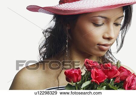 Close-up of a young woman with a bunch of roses View Large Photo Image Stock Photo - Close-up of a young woman with a bunch of roses. Fotosearch