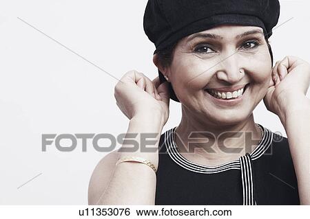 Stock Photograph - Portrait of a mature woman wearing a cap. Fotosearch
