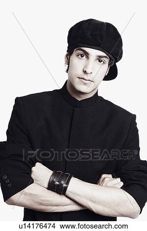 Picture - Portrait of a young man with his arms crossed. Fotosearch