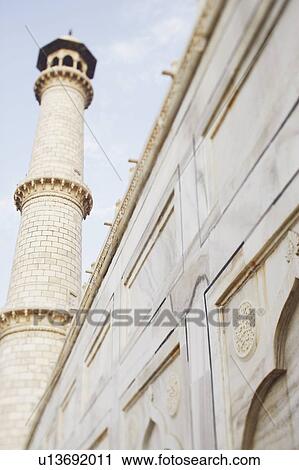 Stock Image - Low angle view of the minaret of a mausoleum, Taj Mahal, Agra, Uttar Pradesh, India. Fotosearch