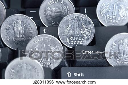 Close-up of Indian one rupee coins on a computer keyboard View Large Photo Image Stock Photograph - Close-up of Indian one rupee coins on a computer keyboard. Fotosearch