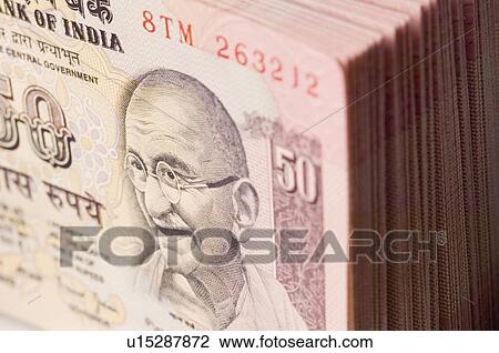 Stock Image - Close-up of picture of Mahatma Gandhi printed on Indian fifty rupee banknote. Fotosearch