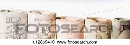 Stock Image - Close-up of rolled up Indian banknotes in a row. Fotosearch