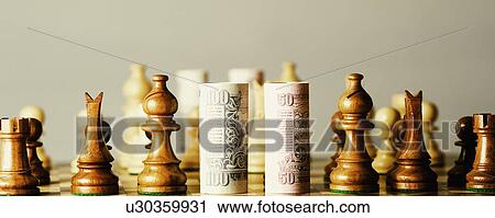 Close-up of rolled up Indian banknotes on a chessboard with chess pieces View Large Photo Image Stock Image - Close-up of rolled up Indian banknotes on a chessboard with chess pieces. Fotosearch