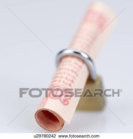 Stock Image - High angle view of an Indian twenty rupee banknote in a padlock. Fotosearch