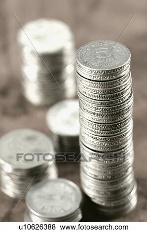 Stock Photo - High angle view of stacks of Indian coins. Fotosearch