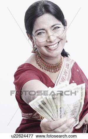 Portrait of a mature woman holding Indian five hundred rupee notes View Large Photo Image Stock Photo - Portrait of a mature woman holding Indian five hundred rupee notes. Fotosearch