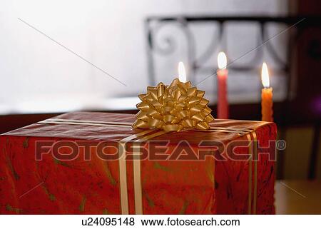 Close-up of a gift with burning candles View Large Photo Image Stock Photo - Close-up of a gift with burning candles. Fotosearch