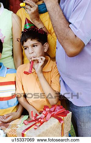 Stock Photo - Group of people celebrating a birthday party. Fotosearch