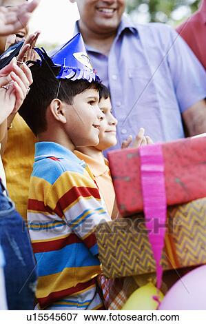 Stock Photo - Group of people celebrating a birthday party. Fotosearch