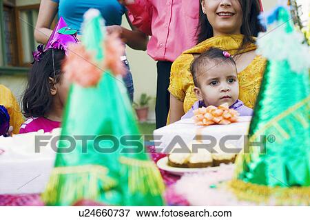 Stock Photo - Group of people celebrating a birthday party. Fotosearch