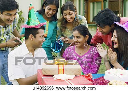 Stock Photograph - Group of people celebrating a birthday party. Fotosearch