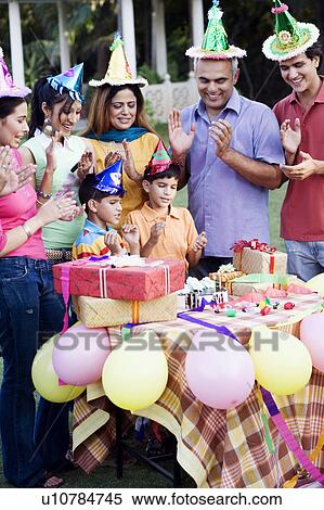 Stock Photography - Group of people celebrating a birthday party. Fotosearch