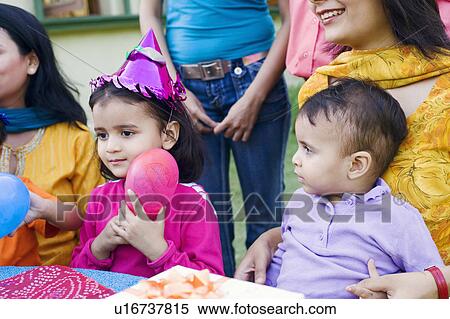 Stock Photography - Group of people celebrating a birthday party. Fotosearch