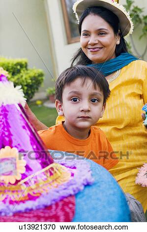 Stock Image - Portrait of a boy with his mother smiling behind him. Fotosearch