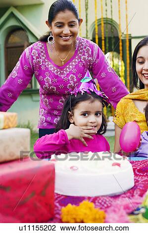 Three people celebrating a birthday party View Large Photo Image Stock Image - Three people celebrating a birthday party. Fotosearch