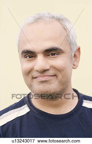 Stock Photo - Close-up of a mid adult man smiling. Fotosearch