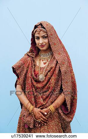 Stock Image - Portrait of a bride in a traditional wedding dress. Fotosearch