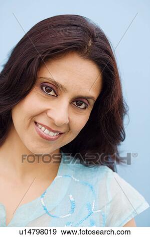 Stock Photo - Portrait of a mid adult woman smiling. Fotosearch
