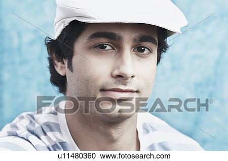 Portrait of a young man wearing a cap View Large Photo Image Stock Image - Portrait of a young man wearing a cap. Fotosearch