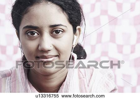 Portrait of a young woman listening to music View Large Photo Image Stock Photography - Portrait of a young woman listening to music. Fotosearch