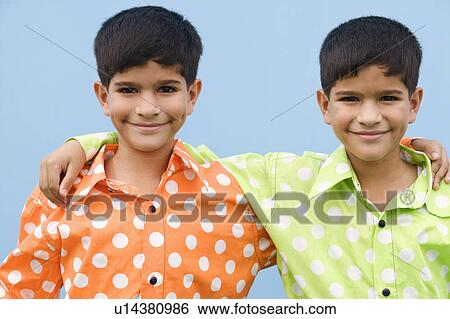 Portrait of twin brothers with their arms around each other View Large Photo Image Stock Photograph - Portrait of twin brothers with their arms around each other. Fotosearch