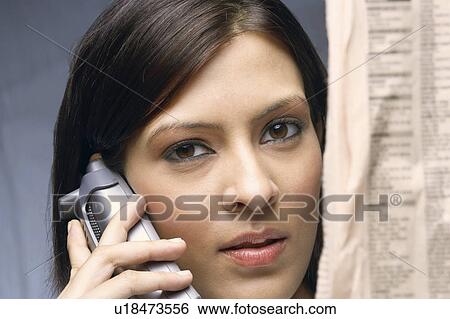 Close-up of a businesswoman talking on a cordless phone View Large Photo Image Stock Photograph - Close-up of a businesswoman talking on a cordless phone. Fotosearch