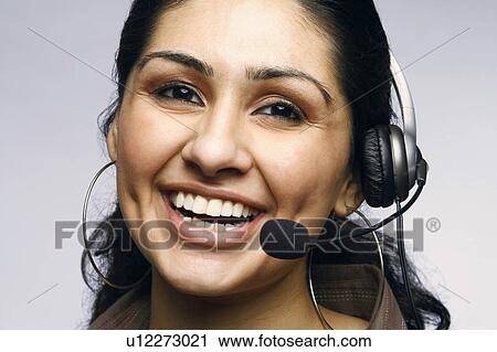 Close-up of a female customer service representative wearing a headset View Large Photo Image Stock Image - Close-up of a female customer service representative wearing a headset. Fotosearch