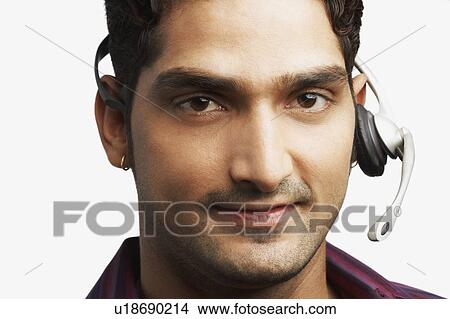 Picture - Portrait of a young man wearing a headset. Fotosearch