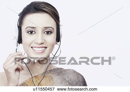 Stock Photo - Portrait of a young woman wearing a headset. Fotosearch