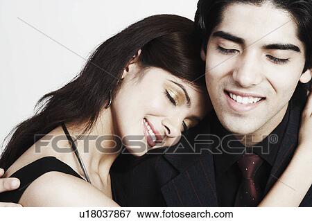 Stock Photo - Close-up of a young couple embracing each other. Fotosearch