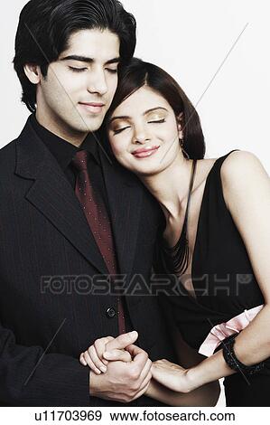 Stock Photo - Close-up of a young couple holding hands. Fotosearch